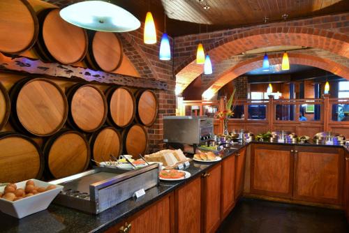 a large kitchen with a bunch of wine barrels at BON Hotel Empangeni in Empangeni