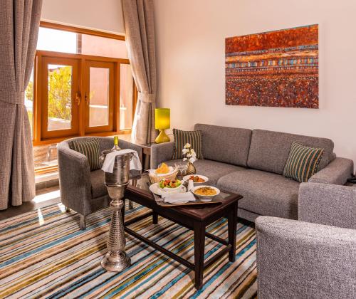 a living room with a couch and a table at Sahab Resort and Spa, Jabal Al Akhdar in Al ‘Aqar