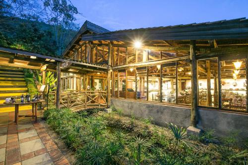 a wooden building with a table in front of it at Sarova Lion Hill Game Lodge in Nakuru