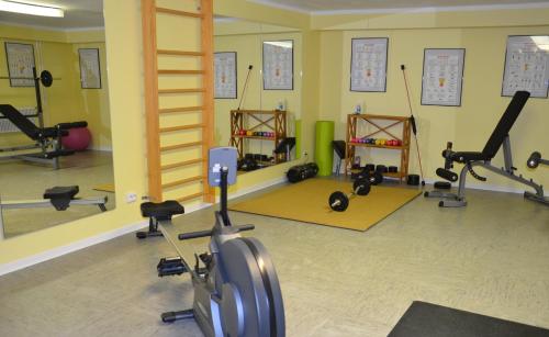 a gym with treadmills and ellipticals in a room at Flair Hotel am Rosenhügel - Garni in Cochem