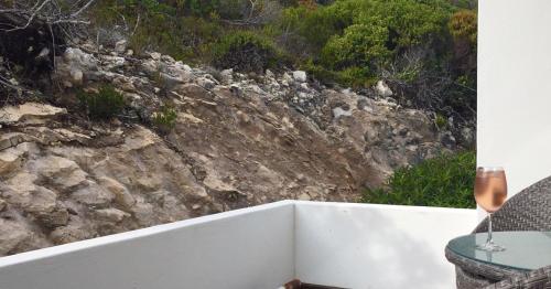 a view of a rocky hill from a balcony at Agulhas Ocean House in Agulhas