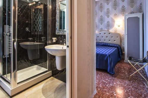 a bathroom with a sink and a shower and a bed at Navona Queen Rooftop in Rome