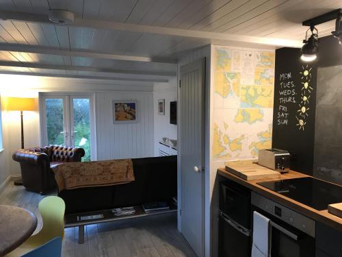 a room with a kitchen and a living room at The Boathouse in Carbis Bay
