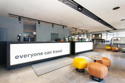 a lobby with a sign that says everyone can travel at a&o Köln Neumarkt in Cologne