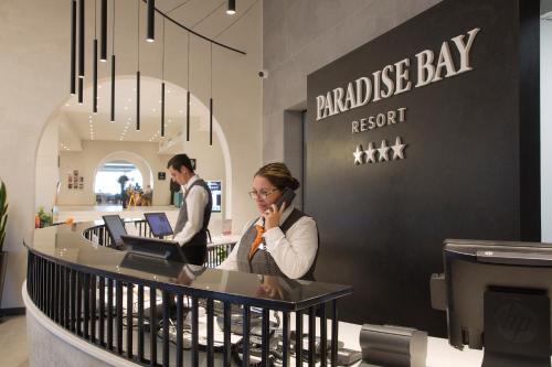 a woman talking on a cell phone in a store at Paradise Bay Resort in Mellieħa