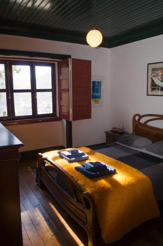 a bedroom with two beds with towels on them at Casa da Sicó in Manteigas