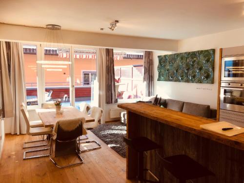 a kitchen and living room with a table and a couch at My Adventure Appartements Schladming by Schladmingurlaub in Schladming