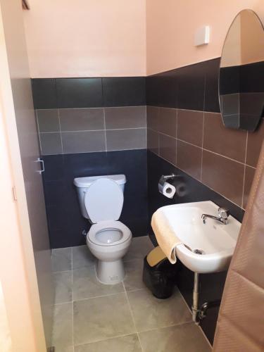 a bathroom with a toilet and a sink at JPH Resort in Malapascua Island