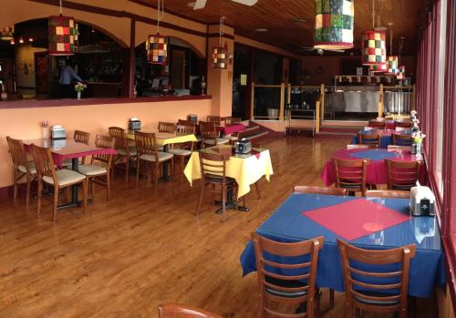 a dining room with tables and chairs in a restaurant at Hospitality Inn in Kamloops