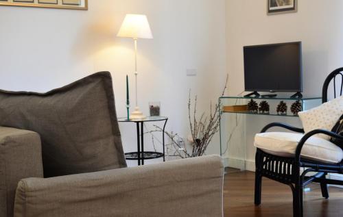 a living room with a couch and a tv at Frasteva Resort in Valverde