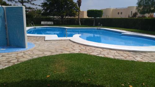 a swimming pool in a yard with a stone walkway around it at Casa Chafarinas in Vera
