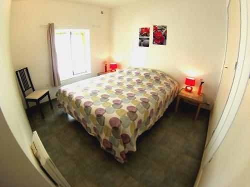 a bedroom with a bed and a table and a window at Le Moulin Des Ocres in Apt