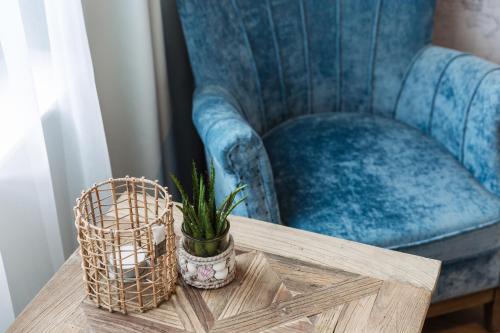 a chair and a table with a plant on it at Hotel Cocoon in Ostend