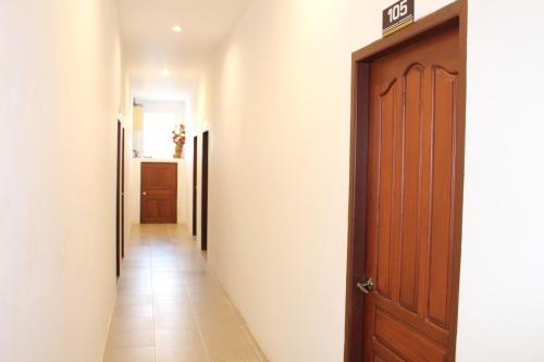 a hallway with a door and a tile floor at avalon residence2 in Savannakhet