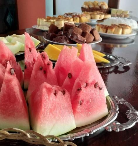 a bunch of watermelon on a plate on a table at Pousada da praça in Morro de São Paulo