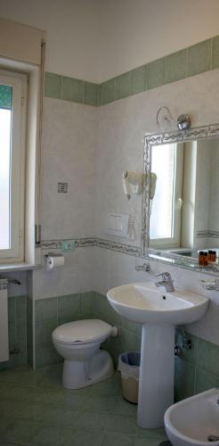 a bathroom with a sink and a toilet and a mirror at B&B La casa D'amare in Maiori