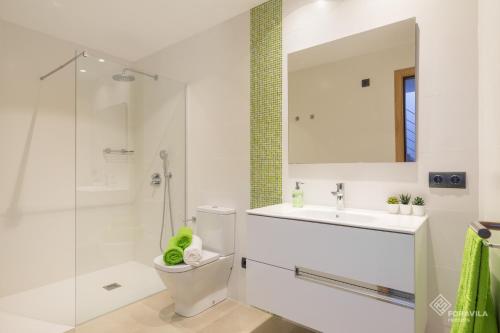 a bathroom with a toilet and a sink and a shower at Ca Na Foc in Sa Pobla