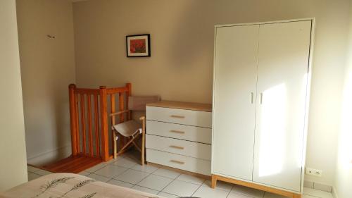 a bedroom with a white cabinet and a dresser at Maisonette en HYPERCENTRE calme avec terrasse in Cholet