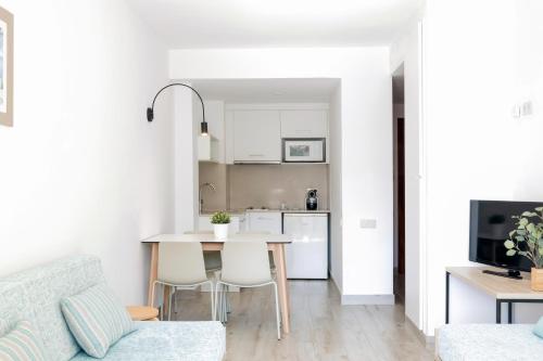 a kitchen and living room with a table and chairs at Aparthotel Cye Holiday Centre in Salou
