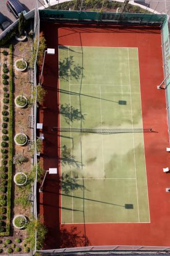 an aerial view of a building with a tennis court at Olympic Residence Deluxe Apartments in Limassol