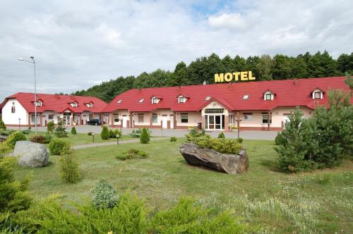 a hotel with a motel sign on the building at Inter-Bar-Motel in Nowe Marzy