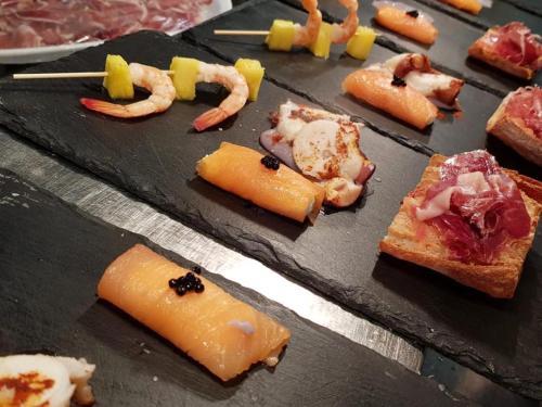 a bunch of different types of food on a table at Hotel Hostal Estrella in Rupit