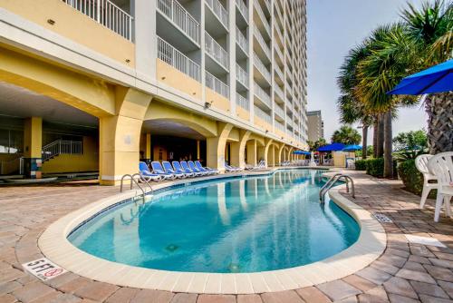 a swimming pool in front of a hotel at Oceanfront Condo Camelot By the Sea in Myrtle Beach
