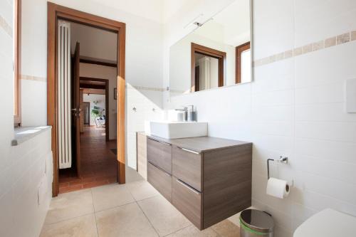 a bathroom with a sink and a mirror at Villa Vinory - La Mandragola in Mombercelli