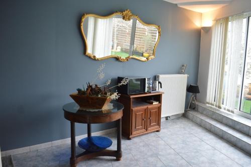 a room with a table and a mirror on the wall at Les remparts d'Angoulême in Angoulême