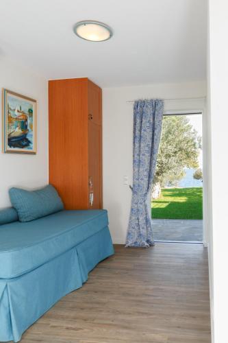 a bedroom with a bed and a sliding glass door at Into The Blue Villa in rkadiko Chorio
