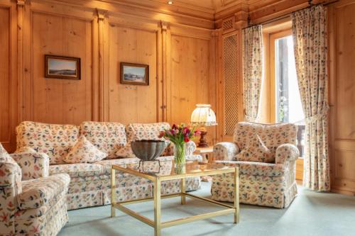 a living room with a couch and two chairs and a table at Adolphine Garden in Rottach-Egern