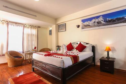 a bedroom with a large bed with red pillows at Thamel Eco Resort in Kathmandu