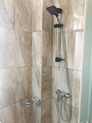 a shower with a shower head in a bathroom at Solomiia in Solochyn