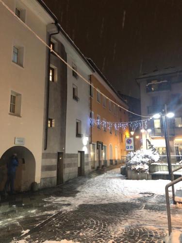 a building with snow on the ground next to a street at Aymon de Challant in Aosta