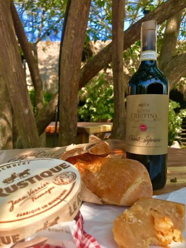 a bottle of wine and bread on a table at Bikini Hotel & Pool in Palomino