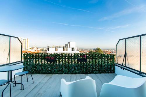 een balkon met stoelen en uitzicht op de stad bij Casa de Cristal in Porto