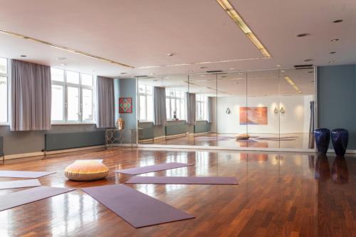 a large room with yoga mats on the floor at Adolphine Garden in Rottach-Egern