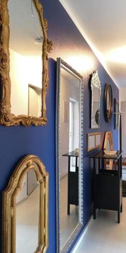 a mirror on a wall next to a table with at Seesterne Residenz in Konstanz