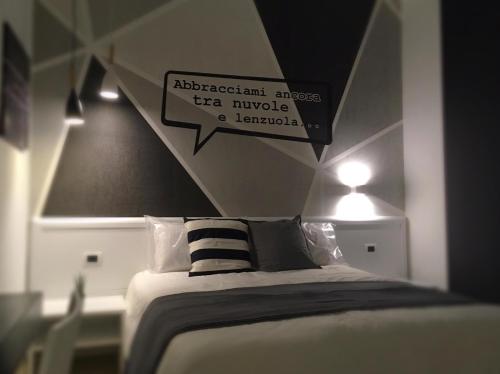a bedroom with a bed with a sign above it at B&B Luna per te in Benevento