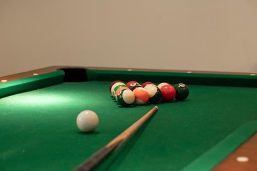 a pool table with a group of balls on it at Villa Adolphine in Rottach-Egern