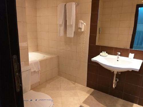 a bathroom with a sink and a toilet at Spa Hotel Kleptuza in Velingrad