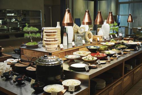 a buffet of food on a table in a restaurant at hotel MONday Premium TOYOSU in Tokyo