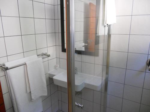 a bathroom with a sink and a mirror at The Lofts in Polokwane
