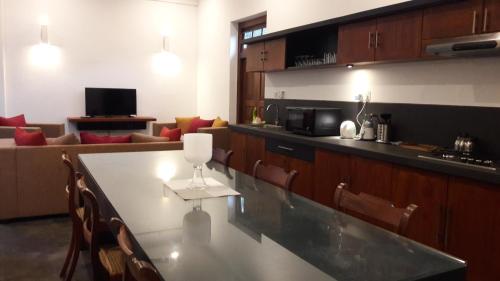 a kitchen with a counter top and a living room at Villa 35F in Galle