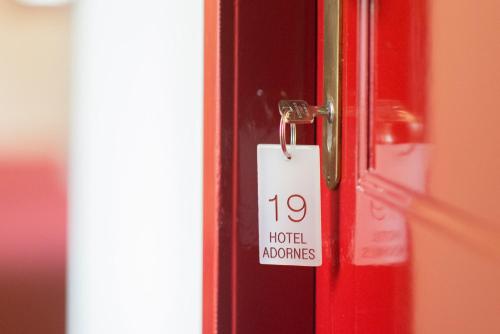 
a red door with a red tag attached to it at Hotel Adornes in Bruges
