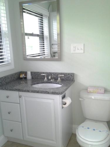 a bathroom with a sink and a toilet at Surf & Sand Beach Motel in South Yarmouth