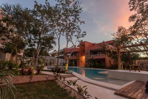 an exterior view of a resort with a swimming pool at Panacea Condo Tulum in Tulum