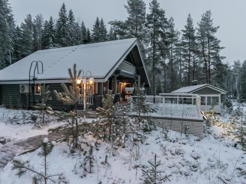a cabin in the woods in the snow at Holiday Home Villa helge by Interhome in Savitaipale