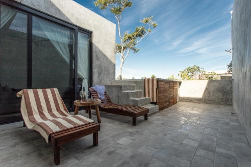 two chairs and a table on a patio at Panacea Condo Tulum in Tulum