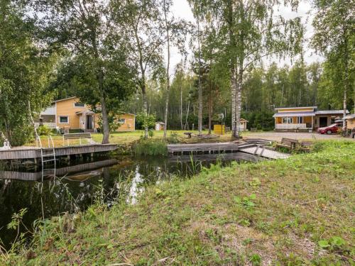 a view of a river with houses in the background at Holiday Home Joutsen by Interhome in Verla